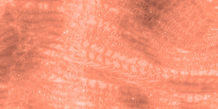 Blur of delicate peach lace fabric with intricate patterns and shimmering textures, creating a soft,...