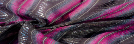 Blur the intertwining stripes of black, purple, and blue fabric. The rich textures and metallic...