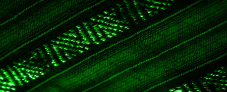 Blurred, the green fabric features abstract patterns with a glowing shine, creating a visually captivating texture. The intertwined fabric and light reflections bring an artistic, modern feel.の写真素材