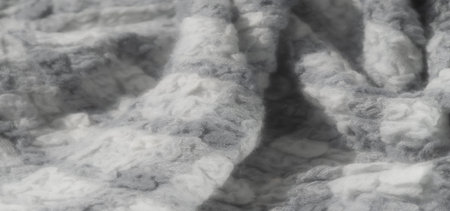 Blur of a fabric pattern in grayscale tones, capturing the subtle complexity of the woven fibers....
