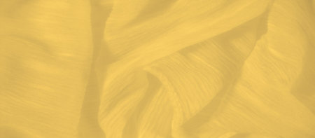 Blur of a bright yellow fabric with rippling folds and a smooth, delicate texture that catches light...