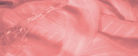 Blur Soft folds of light pink fabric with a delicate, flowing texture. The material appears almost translucent, reflecting light gently across the surface for an ethereal look.の写真素材