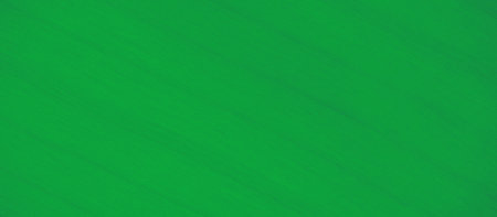 Blur of a vivid green fabric with delicate, flowing textures, creating a soft and serene visual. The fabric's smooth waves and folds are highlighted by its gentle lighting and uniform colorの写真素材