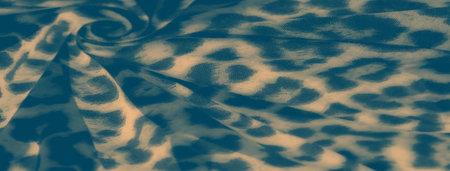 Blurred fabric with a wild, abstract leopard print pattern in neutral hues. The folds and creases give the textile a dynamic, flowing quality, perfect for use in design and fashion.の写真素材