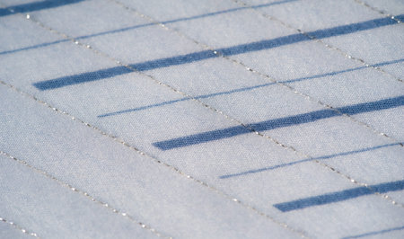 light and shadows gently highlight the shimmering surface of this pastel blue fabric, with delicate...