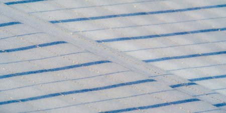 Blur of a light blue striped fabric with a soft sheen, delicately draped to create intricate folds....