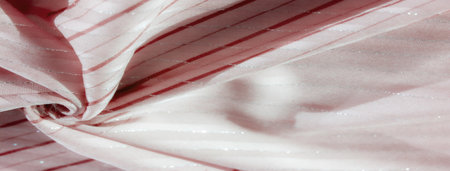 the wavy red lines and soft folds of the white fabric blend harmoniously, creating an abstract and flowing design. Glittering silver lines add a touch of shimmer to the overall look.の写真素材