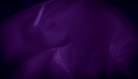 Blurred purple satin fabric with intricate folds and a glossy sheen. The rich purple tones combined with the flowing texture create a sense of luxury and elegance.の写真素材