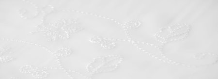 Blur. A high-quality white fabric with intricate, embroidered floral motifs. The gentle folds and...