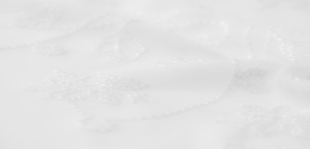 Blur Elegant white fabric featuring soft floral embroidery and smooth folds. The luxurious texture and refined details make it ideal for sophisticated home textiles or fashion applications.の写真素材