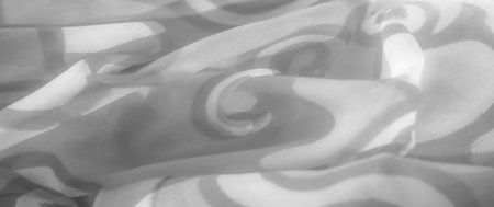 Blur the grayscale fabric with abstract, flowing patterns. The swirling shapes are gently...