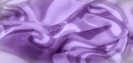 Blur of delicate purple fabric draped with soft, smooth folds and intricate swirl patterns. The...