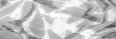 Blur of soft fabric with flowing patterns and folds, creating a serene and elegant visual. The...