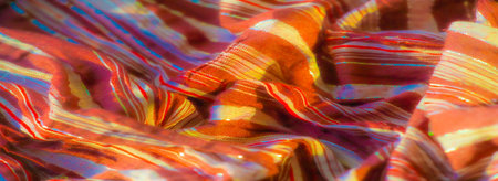 Blur of soft brown fabric with shimmering red and white stripes, artfully arranged in natural folds. The fabric glistens with metallic highlights, evoking a sense of luxury and sophistication.の写真素材