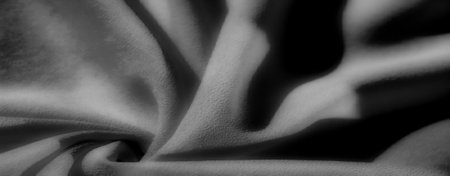 black, Blur, this grayscale fabric shot features dynamic folds and soft textures, with deep shadows playing off the surface to create a captivating, abstract visual.の写真素材