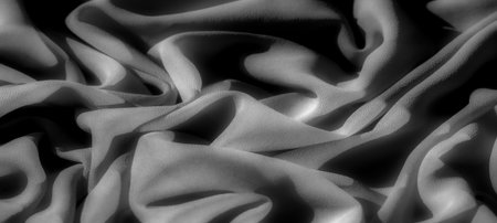 black Blur, the fabric in this photo is elegantly draped, with smooth folds casting deep shadows, creating a textured, monochromatic pattern that emphasizes the interplay of light and darkness.の写真素材