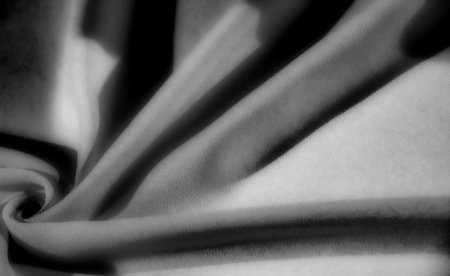 black, Blur, this grayscale fabric shot features dynamic folds and soft textures, with deep shadows playing off the surface to create a captivating, abstract visual.の写真素材