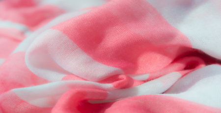 Blur of a pink and white striped fabric with soft, flowing folds. The smooth texture and alternating pastel colors create a light and delicate feel, perfect for background or fashion concepts.の写真素材