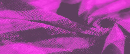 Blur the folded pink and black plaid fabric with its intricate woven texture and small shadows, creating a subtle play of light. The checkered design brings a classic pattern into focus.の写真素材