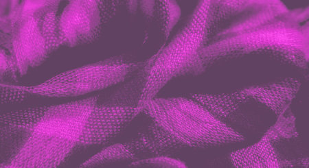 Blurred image of a purple fabric with a black and pink checkered pattern. The soft fabric's texture...