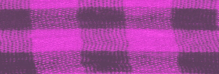 Blur the fabric pattern with bold pink and black checks creates a visually striking texture. The folds in the fabric add depth, making the material appear dynamic and full of motion.の写真素材
