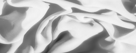 Blur: Soft grayscale fabric with gentle curves and folds, highlighted by the play of light and shadows, creating an elegant, flowing pattern.の写真素材