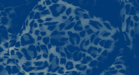 Blurred patterned fabric in blue tones with organic abstract prints. Soft light plays across the folds, enhancing its depth and giving it a serene visual appeal, ideal for design.の写真素材