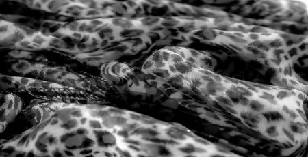 Blurred image of delicate fabric with bold black patterns on a transparent background. The organic...