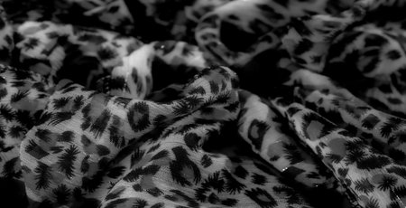 Blurred, sheer fabric with a bold, abstract black design. The flowy texture and light play give a soft, ethereal appearance, enhancing the modern aesthetic.の写真素材