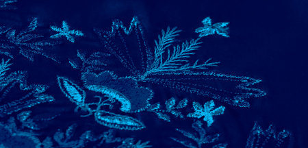 Blur of deep blue fabric flows in smooth, elegant waves, casting delicate shadows and highlights...