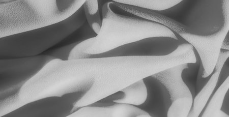 Blur: Soft grayscale fabric with intricate folds and subtle textures, casting gentle shadows and...