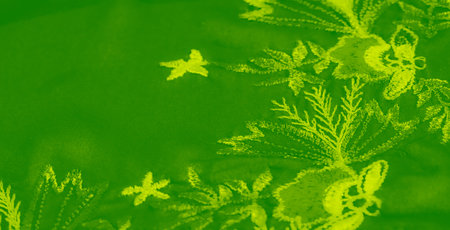 Blur, a vibrant green fabric with detailed floral embroidery, showcases intricate leaf and branch...