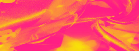 Blurred layers of neon pink and yellow fabric intertwine, creating a glowing effect with floral accents. The translucent texture and vibrant hues give it an artistic, radiant look.の写真素材