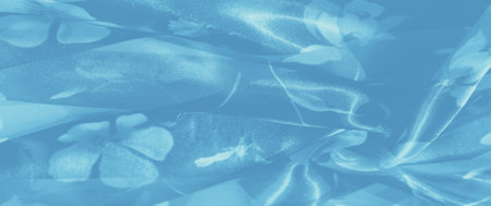 Blur of soft blue fabric layered with a gentle floral pattern, capturing light and adding a subtle, tranquil shimmer. Perfect for enhancing a peaceful interior.の写真素材