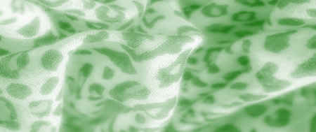 Blur. Green leopard print fabric with soft folds and a playful pattern, offering a unique mix of...