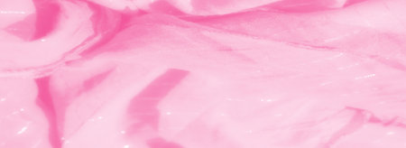 Blur of delicate pink fabric with soft folds and subtle glossy highlights, capturing a luxurious, gentle texture with an ethereal and refined appearance perfect for fashion design.の写真素材