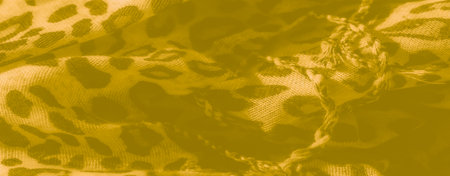 Blur - Yellow fabric featuring an abstract animal-inspired print, subtly textured with woven detailing. The light enhances its soft folds, adding a gentle, warm atmosphere.の写真素材
