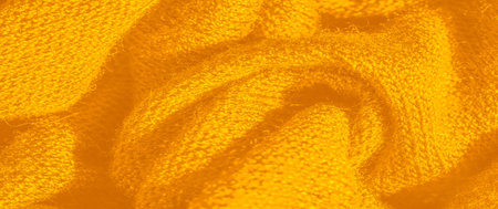 Blur. This close-up of yellow fabric reveals a rich texture and flowing folds, creating an abstract...