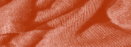 Blur The image presents a textured orange fabric with soft, delicate folds, creating intricate...