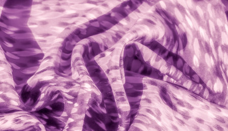 Blur of a delicately textured purple fabric with flowing folds and a spotted, leopard-like pattern...