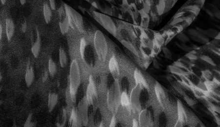 Blur effect enhances the fabric's grayscale pattern with soft waves and fluid textures, creating a sophisticated visual appeal perfect for artistic designs.の写真素材