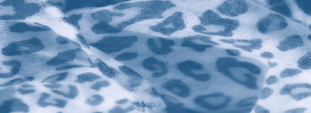 Blur: An artistic close-up of blue and white fabric in leopard print pattern, softly folded with a blurred effect, creating a modern and tranquil look on the textile surface.の写真素材