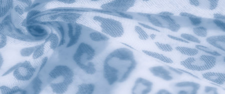 Blur effect captures a close-up of soft fabric in calming blue hues with a leopard-inspired pattern. Gentle folds and intricate details create a subtle depth, perfect for design and fashion purposes.の写真素材
