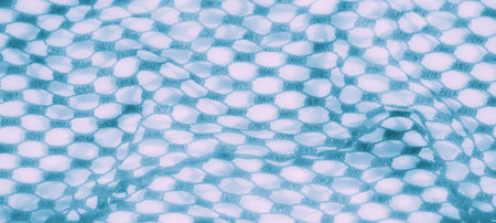Blur effect showing a delicate mesh of intricate blue fabric with a grid-like design. The soft, pastel hues create a dreamy, abstract impression, perfect for a gentle aesthetic.の写真素材
