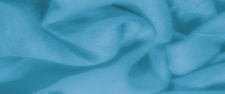 Blurred turquoise fabric with smooth, flowing folds, delicately textured to create a harmonious...