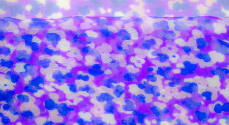 Blur of purple and blue abstract floral patterns flowing across sheer fabric, creating a dreamy, watercolor-like effect with soft, overlapping shapes.の写真素材