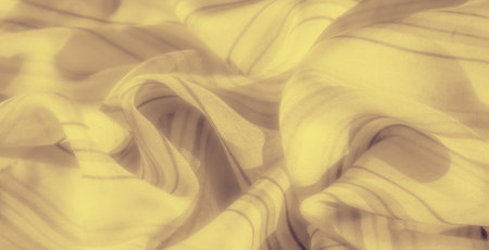 Blurred and softly draped yellow fabric, accentuated with faint stripes and delicate folds, offers a serene and refined look. The fabric's smooth texture sの写真素材