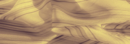 Blurred soft yellow fabric with flowing, translucent texture and faint stripe patterns, creating a sense of depth and smooth movement. The gentle folds offer a calming, ethereal visual.の写真素材