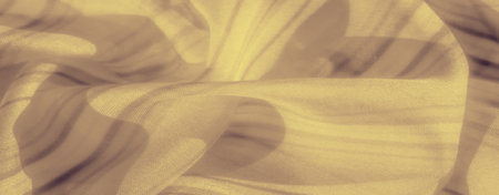 Blur unveils a smooth yellow fabric with subtle striped details, gracefully flowing to create soft shadows and a sense of delicate elegance.の写真素材