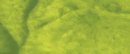 Blur. A mesmerizing green fabric with swirled and floral patterns, offering a vibrant, textured appearance. This textile's organic flow and high detail add beauty and style to creative applications.の写真素材
